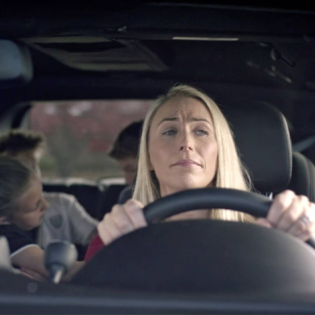 photo of woman driving her family in an SUV