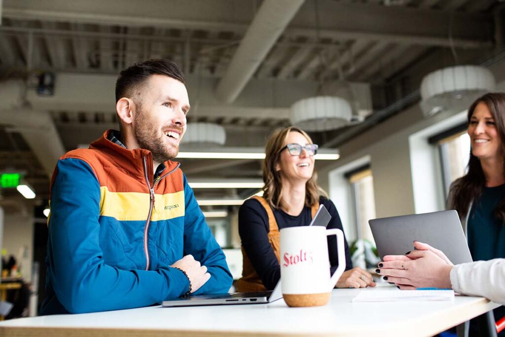 Stoltz employees talking around a table