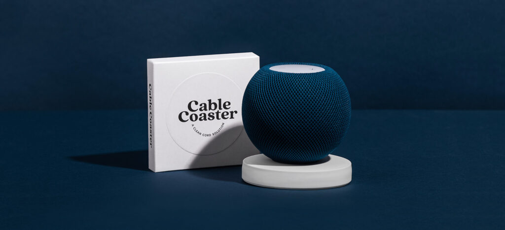 Packaging design for cable coaster product. Blue speaker shown on a white cable coaster.