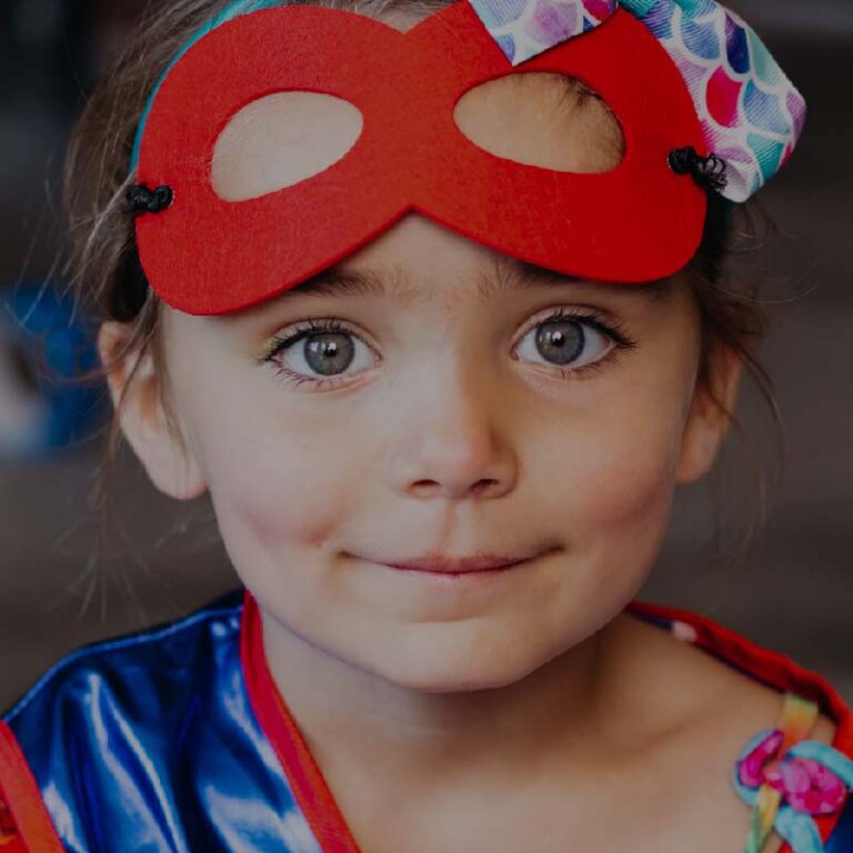photo of a blue-eyed child in a superhero outfit