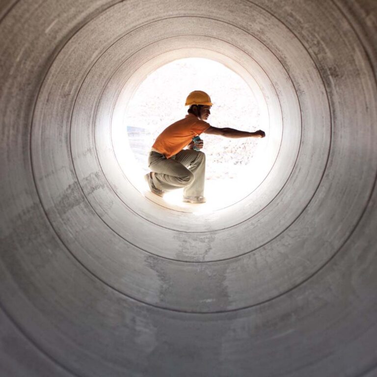 Man in a water pipe for Itron energy marketing agency