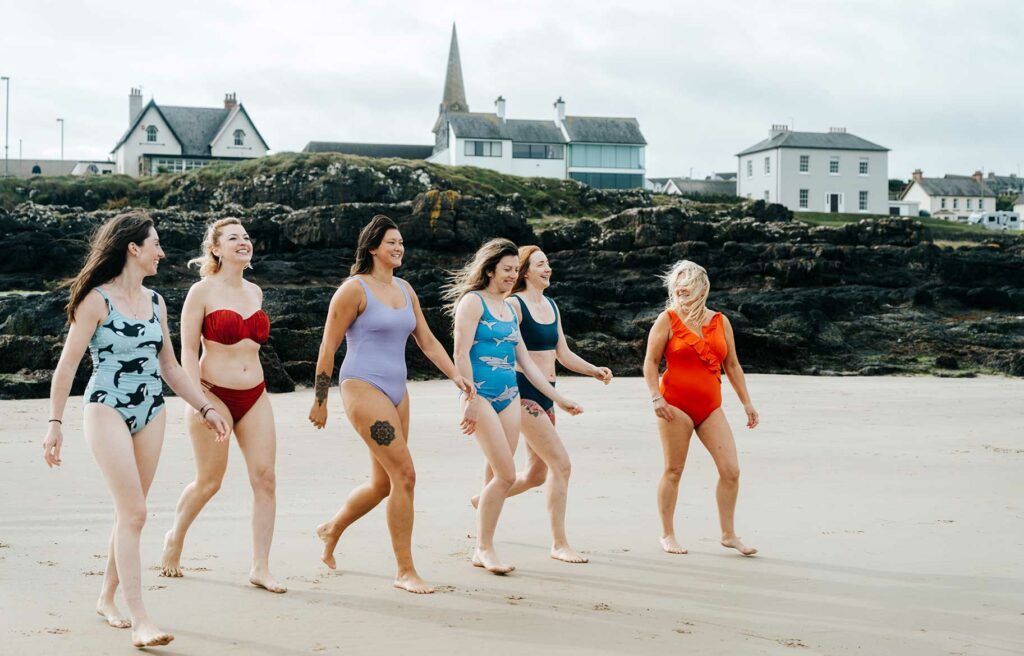 Salty Sea Sisters in a group walking on the beach