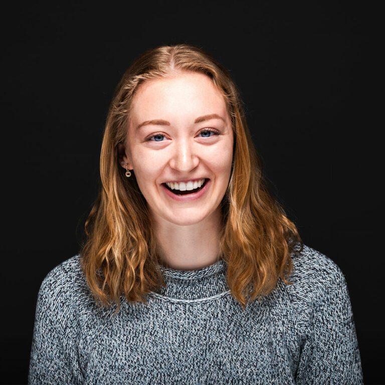 Headshot photograph of Clara Adams, smiling