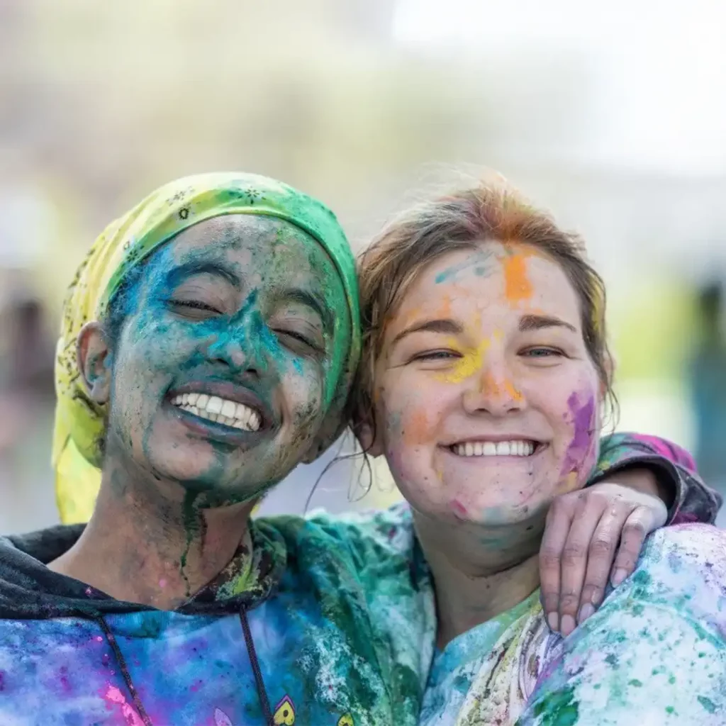 Photo of Batuo Olana and her friend with paint on their faces