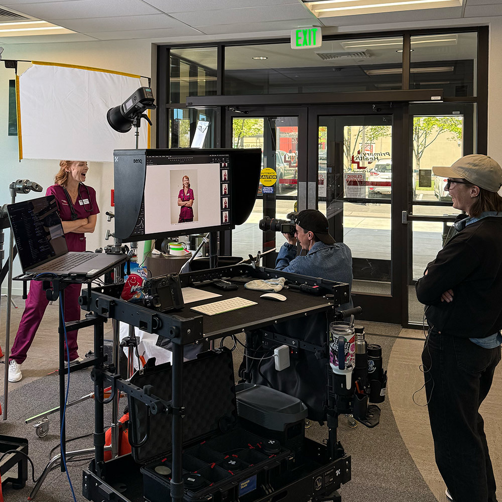 Photographer captures a nurse in scrubs during a Primary Health photoshoot inside a clinic.