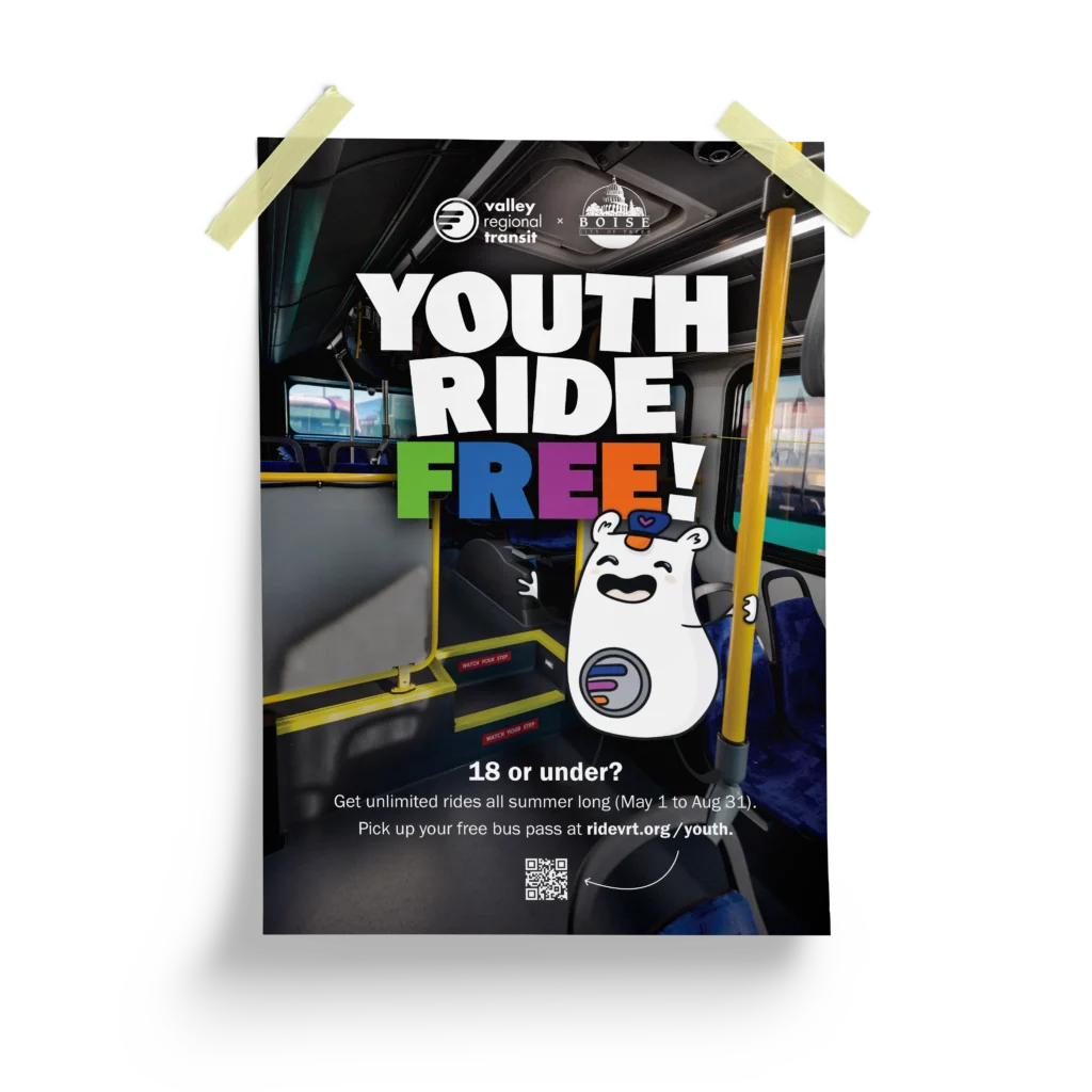 A poster that says Youth Ride Free! There is information about the program on it with a Lil Rider hanging on to a bus pole inside the bus.